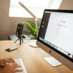 SEO A modern workspace with an iMac displaying Google search, perfect for remote work setups.