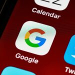 SEO Macro view of a smartphone displaying Google and other app icons on the home screen.